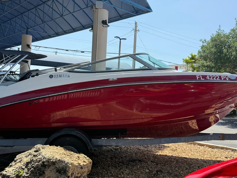 Slide: The Image of 2015 Yamaha Boats SX192 in vibrant red, displayed outdoors on a trailer. - 4