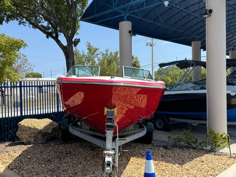 Slide: The Image of 2015 Yamaha Boats SX192 in vibrant red, displayed on a trailer outdoors. - 5