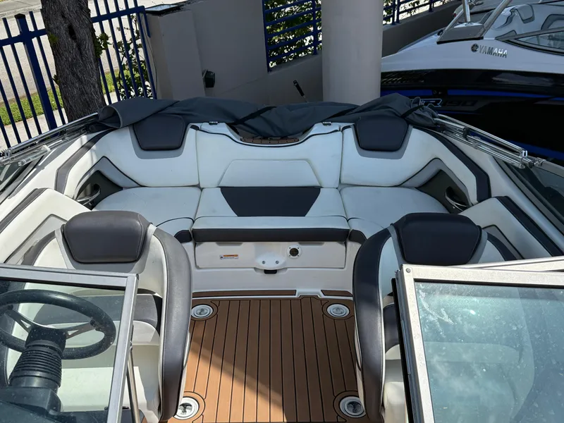 Slide: The Image of 2015 Yamaha Boats SX192 interior with white seating and wooden deck. - 7