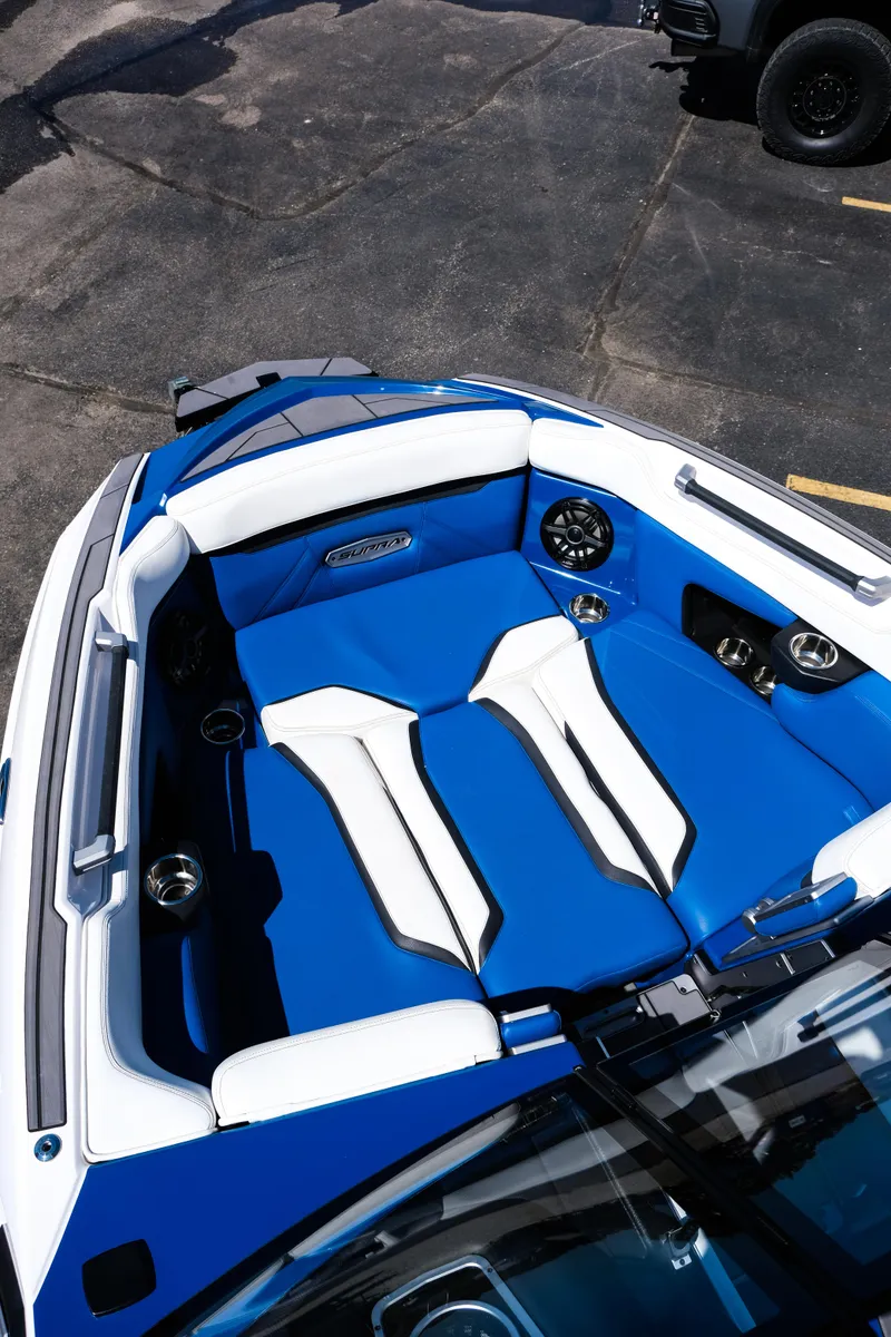Slide: The Image of 2023 Supra SL boat interior with blue and white seating, featuring modern design and speakers. - 12