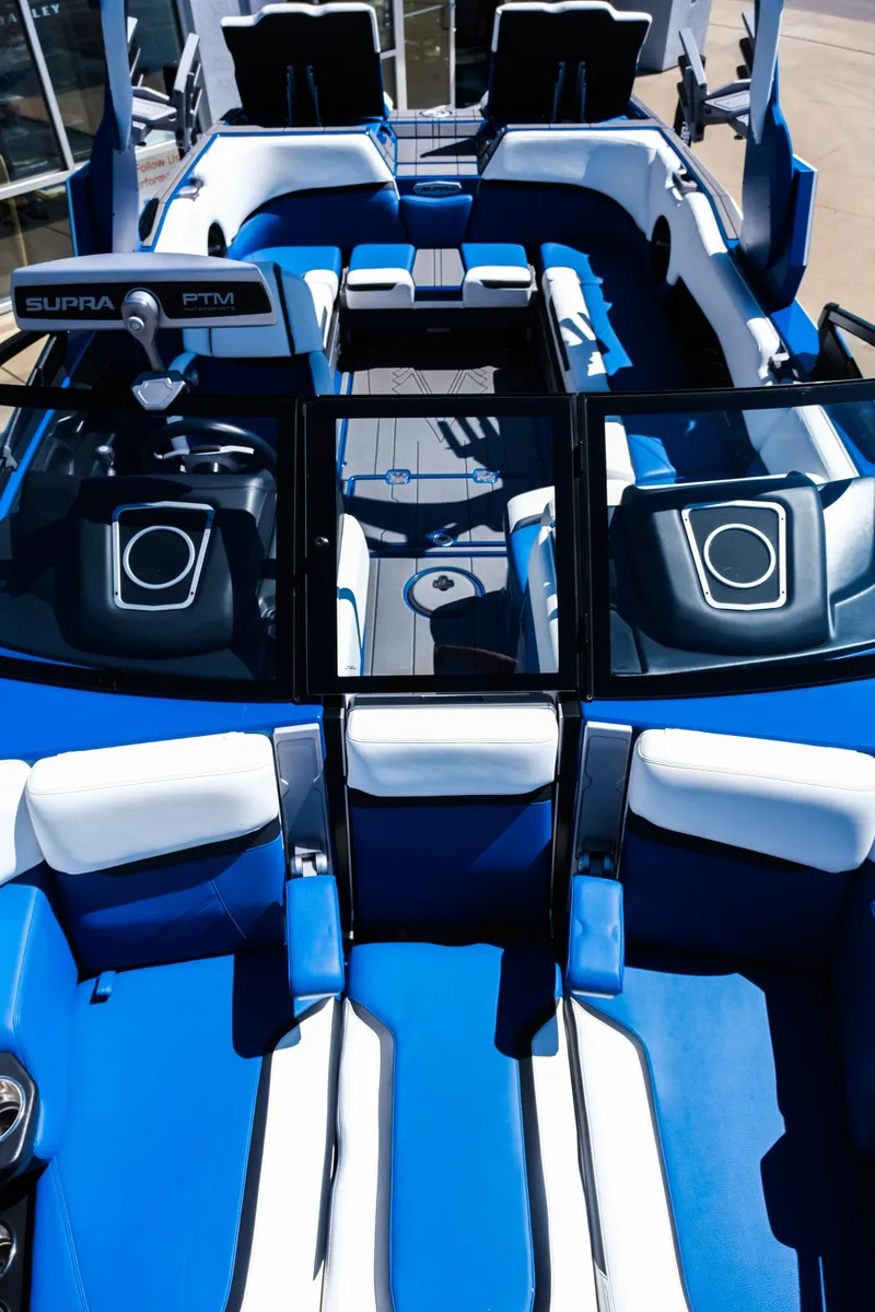 Slide: The Image of 2023 Supra SL boat interior with blue and white seating, modern design, and advanced features. - 13