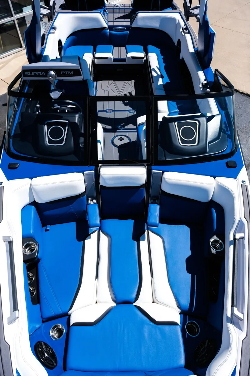 Slide: The Image of 2023 Supra SL boat interior with blue and white seating, modern design, and premium audio system. - 14