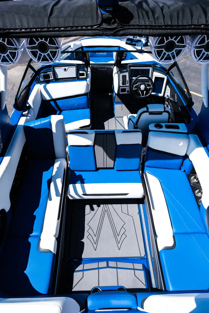 Slide: The Image of 2023 Supra SL boat interior with blue and white seating, advanced dashboard, and premium sound system. - 3