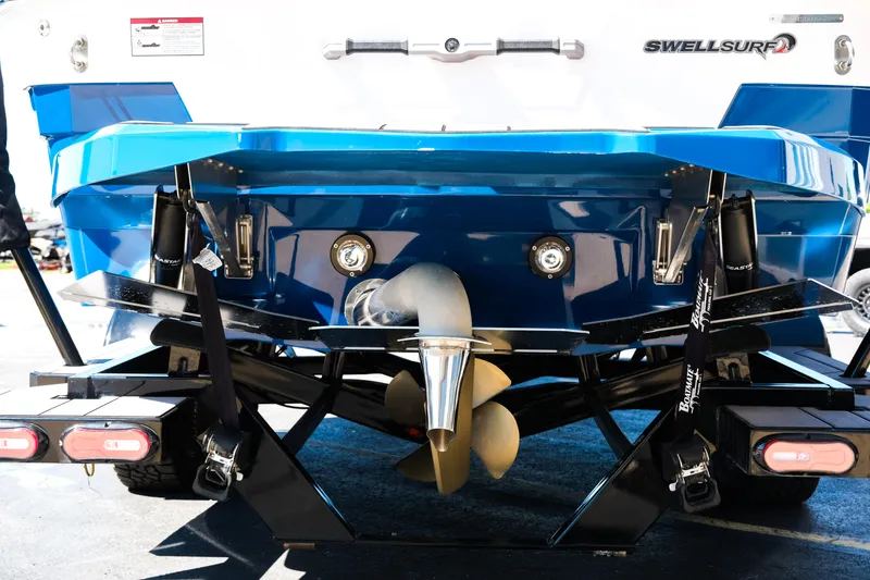 Slide: The Image of 2023 Supra SL boat rear view showcasing propeller and SwellSurf system. - 5
