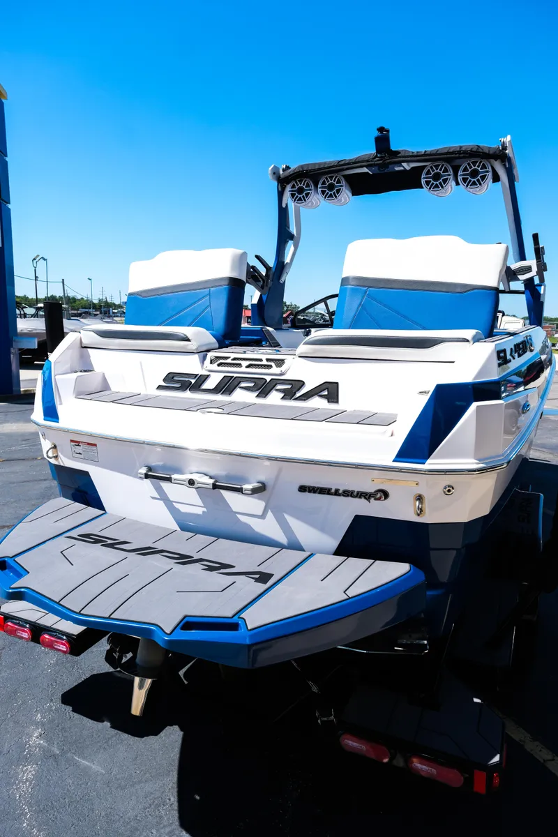 Slide: The Image of 2023 Supra SL boat with sleek design, blue and white color scheme, and advanced features. - 7