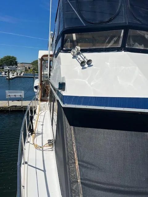 Slide: The Image of 1990 Jefferson 42 Viscount Sundeck yacht docked at marina, sunny day. - 12