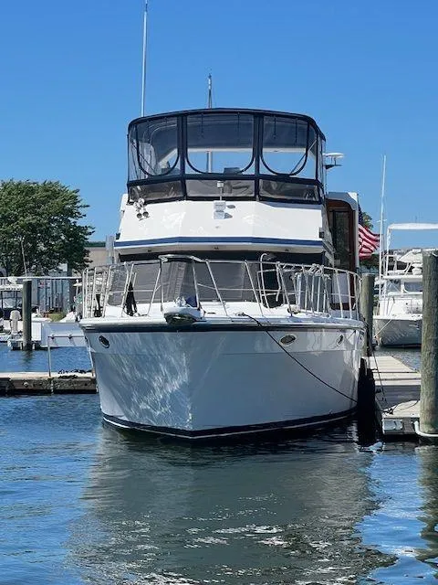 Slide: The Image of 1990 Jefferson 42 Viscount Sundeck yacht docked at marina on a sunny day. - 13