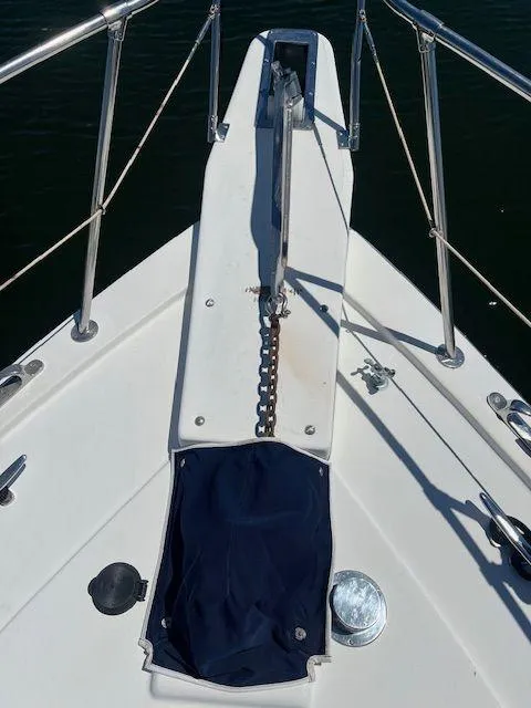 Slide: The Image of Bow of 1990 Jefferson 42 Viscount Sundeck yacht with anchor chain and railing. - 15