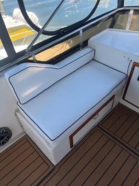 Slide: The Image of 1990 Jefferson 42 Viscount Sundeck interior with white cushioned seating and wood accents. - 31