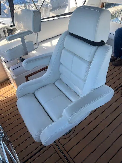Slide: The Image of White captain's chair on 1990 Jefferson 42 Viscount Sundeck, teak flooring background. - 33