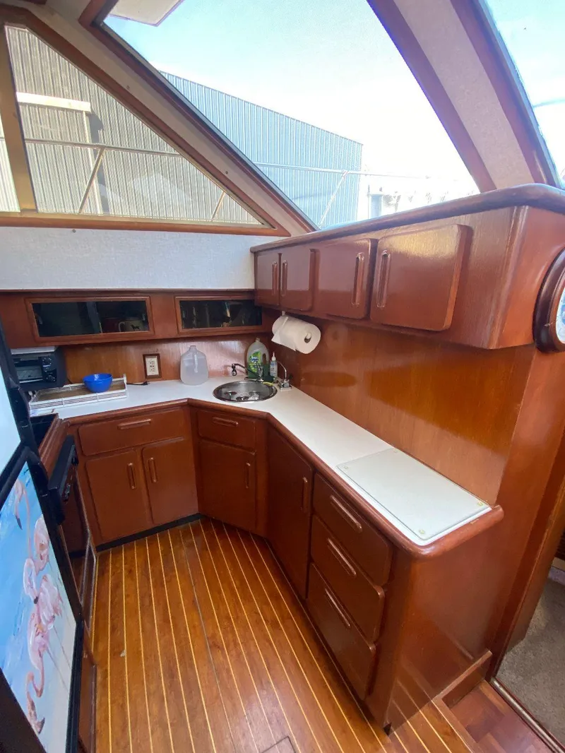 Slide: The Image of 1990 Jefferson 42 Viscount Sundeck yacht kitchen with wood cabinetry and countertops. - 37