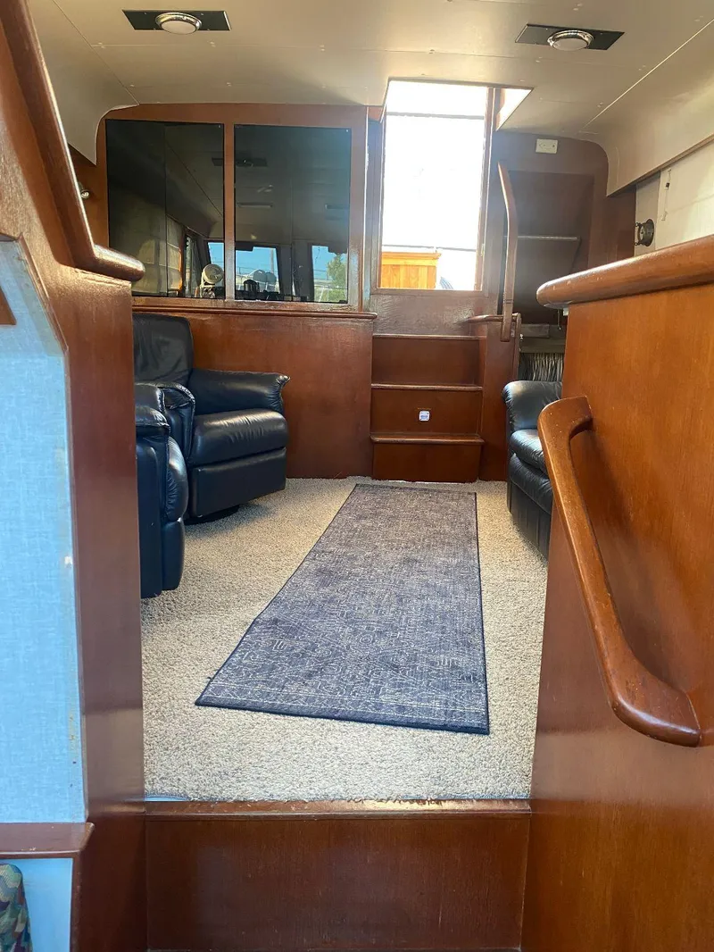 Slide: The Image of Interior of 1990 Jefferson 42 Viscount Sundeck yacht with leather seating and carpeted floor. - 39