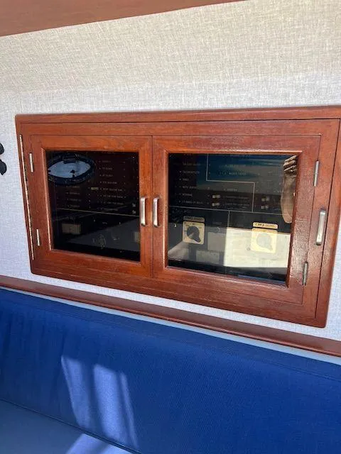 Slide: The Image of 1990 Jefferson 42 Viscount Sundeck interior with wooden cabinet and blue seating. - 41