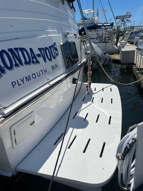 Slide: The Image of 1990 Jefferson 42 Viscount Sundeck docked in Plymouth, MA, with visible swim platform. - 7