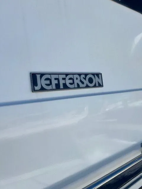 Slide: The Image of 1990 Jefferson 42 Viscount Sundeck boat logo on white surface. - 8