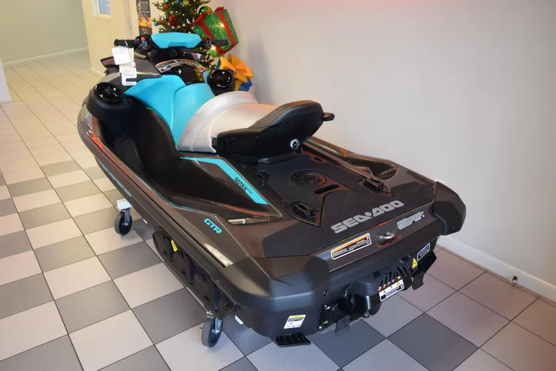 Slide: The Image of 2024 Sea-Doo GTR 230 jet ski in showroom, featuring sleek design and vibrant colors. - 3