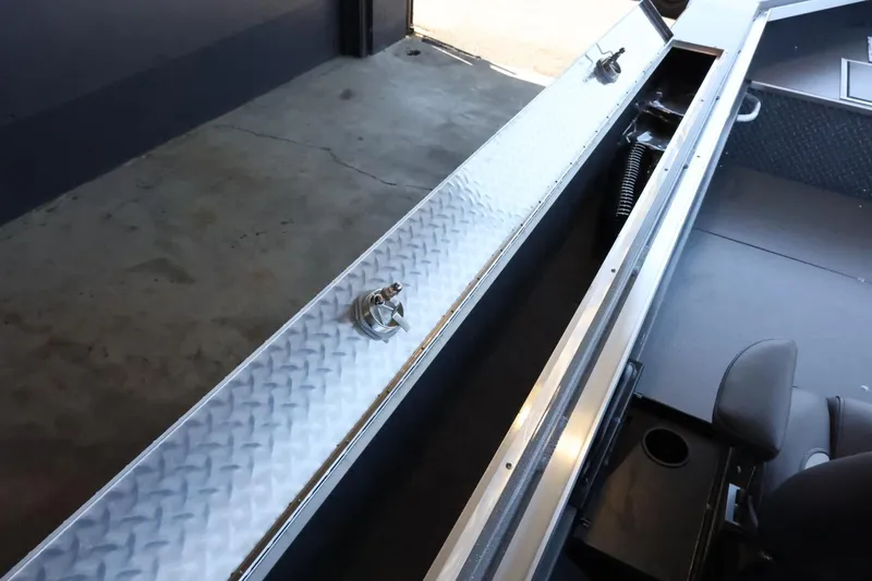 Slide: The Image of Interior view of 2025 Thunder Jet 209 Rush OT boat, featuring storage compartments and seating. - 16