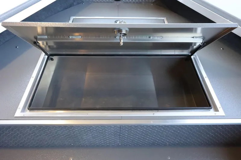 Slide: The Image of Open storage compartment in 2025 Thunder Jet 209 Rush OT boat. - 18