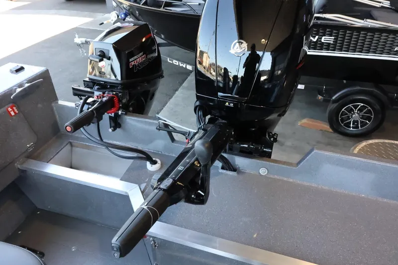 Slide: The Image of 2025 Thunder Jet 209 Rush OT boat with dual outboard motors in a showroom. - 25