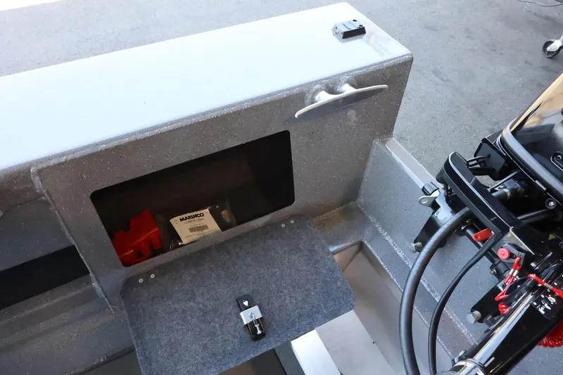 Slide: The Image of 2025 Thunder Jet 209 Rush OT boat interior with storage compartment and motor controls. - 28