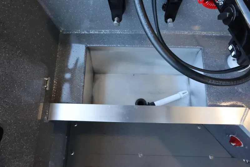 Slide: The Image of Interior view of 2025 Thunder Jet 209 Rush OT boat, showcasing storage compartment. - 29