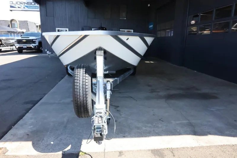 Slide: The Image of 2025 Thunder Jet 209 Rush OT boat on trailer, parked outside a marine dealership. - 3