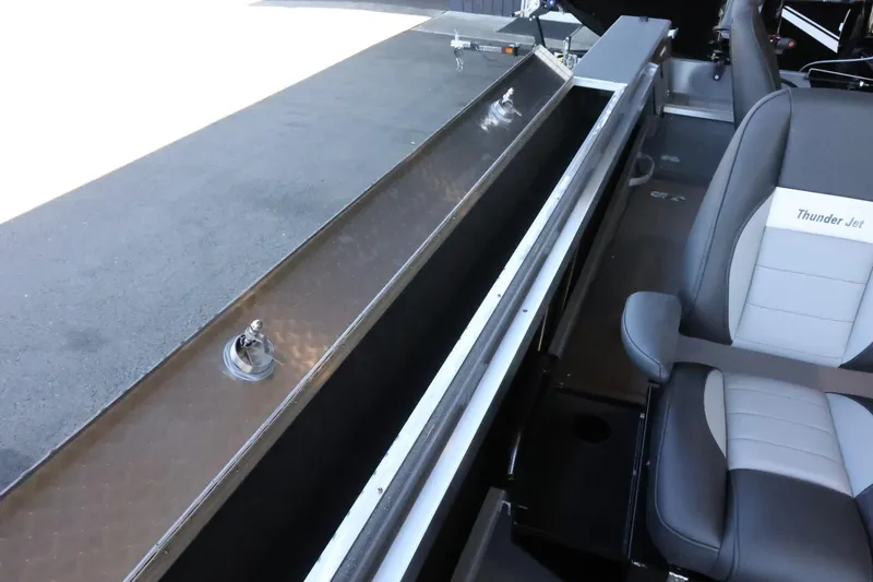 Slide: The Image of 2025 Thunder Jet 209 Rush OT boat interior with seating and storage compartment. - 31