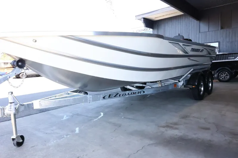 Slide: The Image of 2025 Thunder Jet 209 Rush OT boat on EZ Loader trailer in a garage. - 4