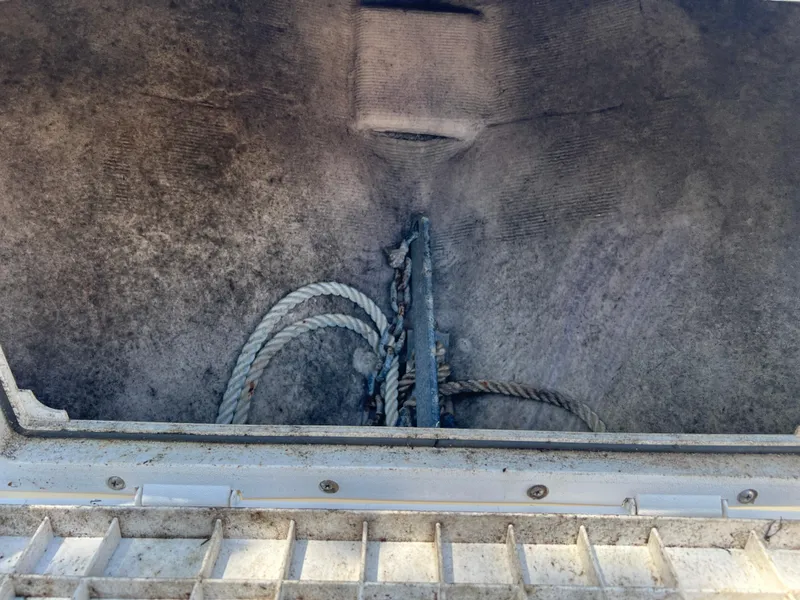 Slide: The Image of Anchor storage compartment with ropes in a 2001 Aquasport 200 Osprey boat. - 10