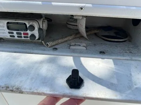 Slide: The Image of 2001 Aquasport 200 Osprey boat radio compartment with communication device and coiled cable. - 11