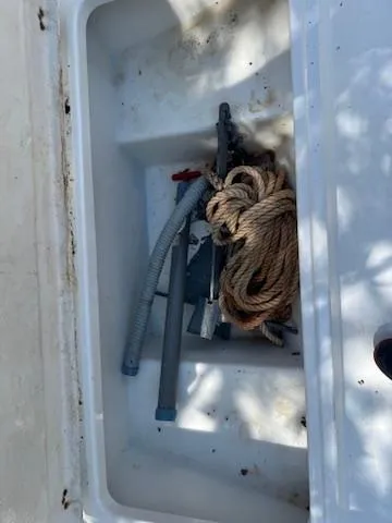 Slide: The Image of Storage compartment of 2001 Aquasport 200 Osprey with rope and hose inside. - 13