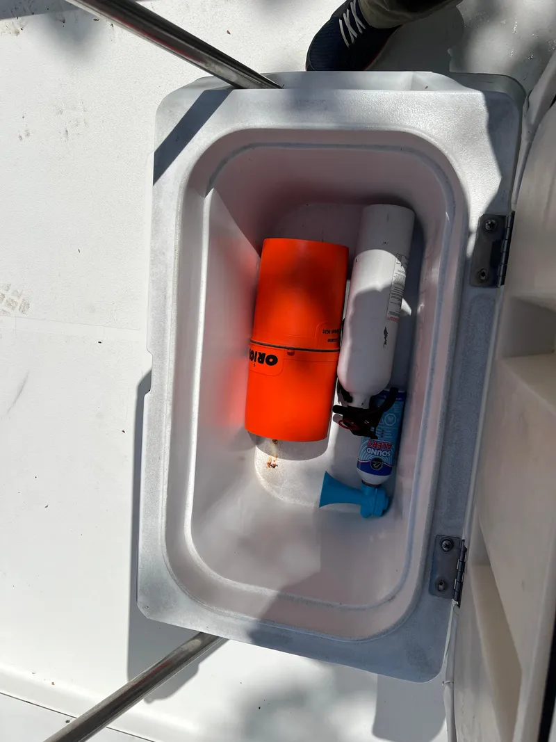 Slide: The Image of Storage compartment on 2001 Aquasport 200 Osprey boat with safety equipment. - 14