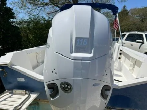 Slide: The Image of 2001 Aquasport 200 Osprey boat with 115 HP outboard motor, parked outdoors. - 17
