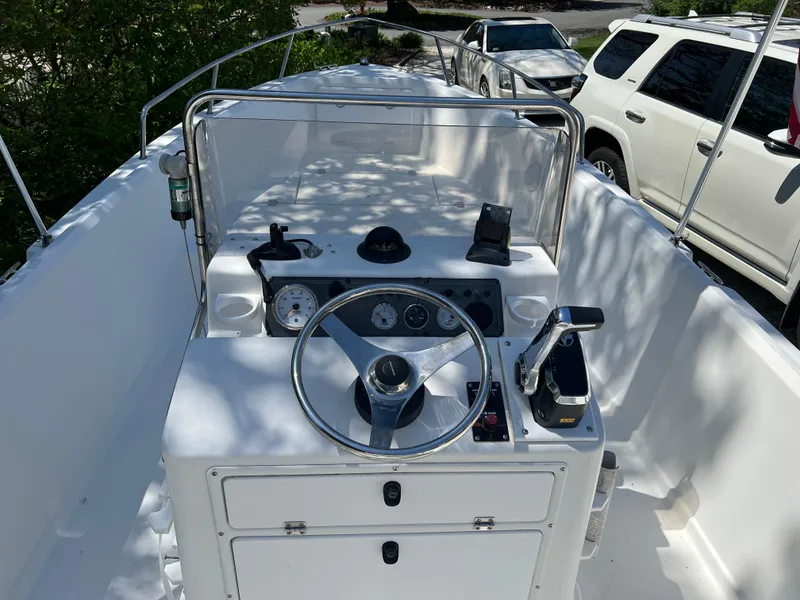 Slide: The Image of 2001 Aquasport 200 Osprey boat console with steering wheel and controls. - 3