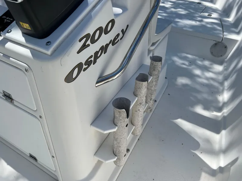 Slide: The Image of 2001 Aquasport 200 Osprey boat interior with rod holders and console details. - 4