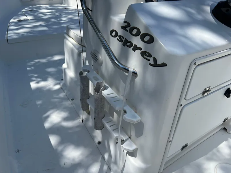 Slide: The Image of 2001 Aquasport 200 Osprey boat interior with rod holders and storage compartments. - 5