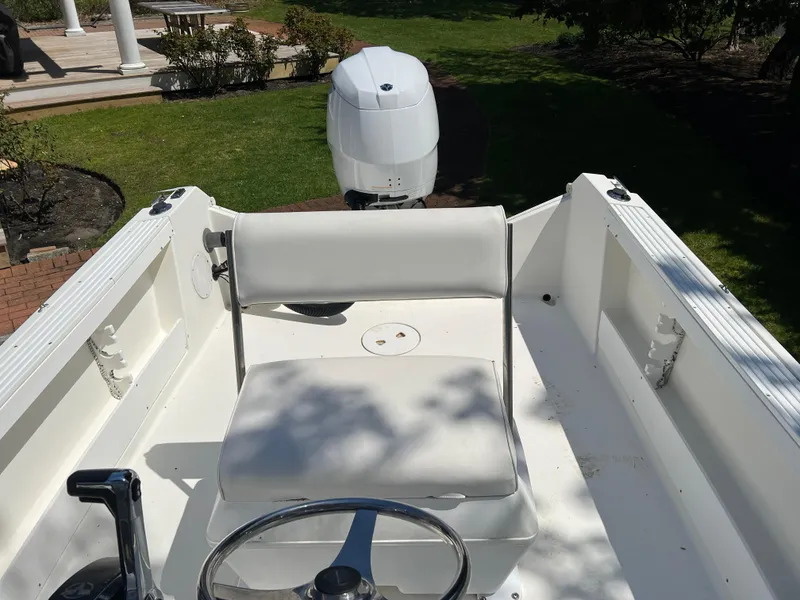 Slide: The Image of 2001 Aquasport 200 Osprey boat interior with steering wheel and seating. - 7