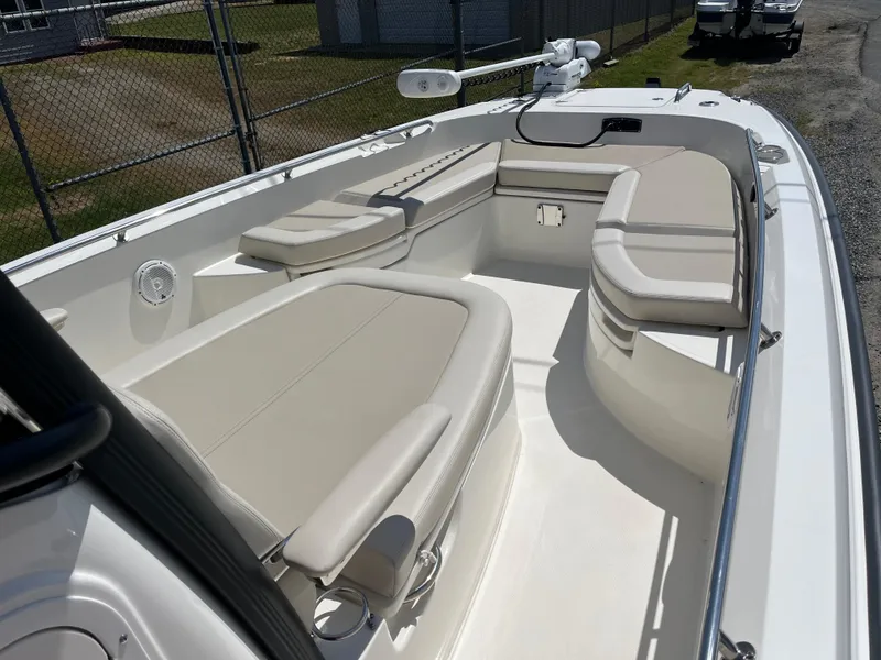 Slide: The Image of 2022 Boston Whaler 270 Dauntless boat interior with beige seating and spacious layout. - 10