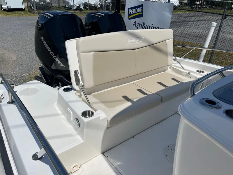Slide: The Image of 2022 Boston Whaler 270 Dauntless boat with beige seating and dual Mercury engines. - 12