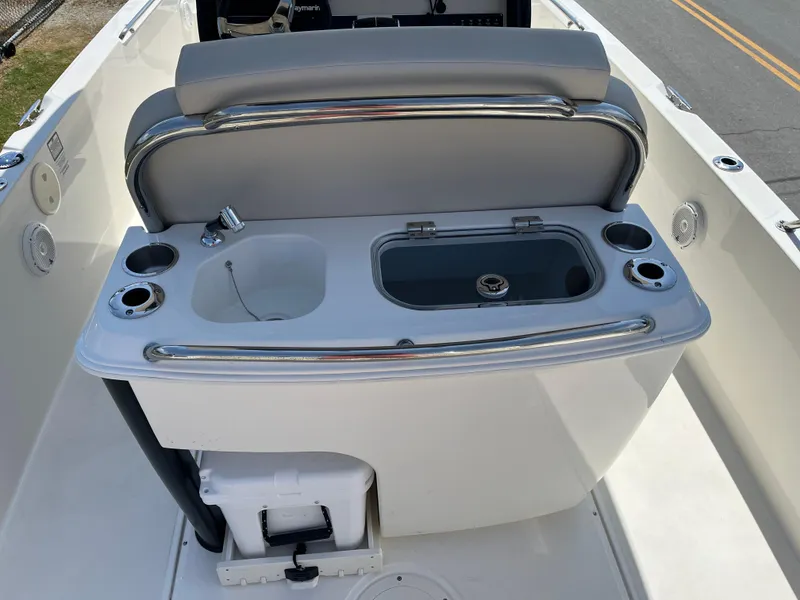 Slide: The Image of 2022 Boston Whaler 270 Dauntless boat console with sink and storage compartments. - 13