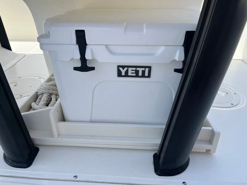 Slide: The Image of YETI cooler on 2022 Boston Whaler 270 Dauntless boat deck, with storage compartment. - 14
