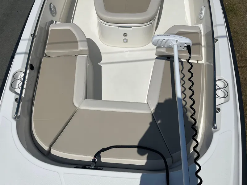 Slide: The Image of 2022 Boston Whaler 270 Dauntless boat interior with beige seating and trolling motor. - 15