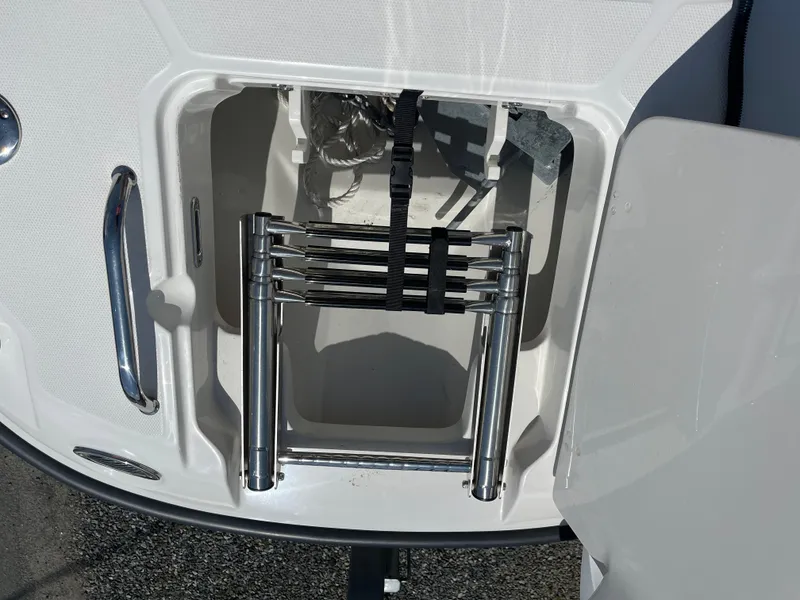 Slide: The Image of 2022 Boston Whaler 270 Dauntless boat ladder compartment with stainless steel ladder. - 16