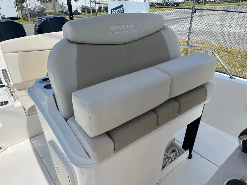 Slide: The Image of 2022 Boston Whaler 270 Dauntless boat seating, featuring comfortable beige upholstery. - 19