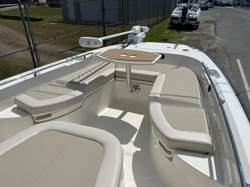 Slide: The Image of 2022 Boston Whaler 270 Dauntless boat with spacious seating and table in the bow area. - 5