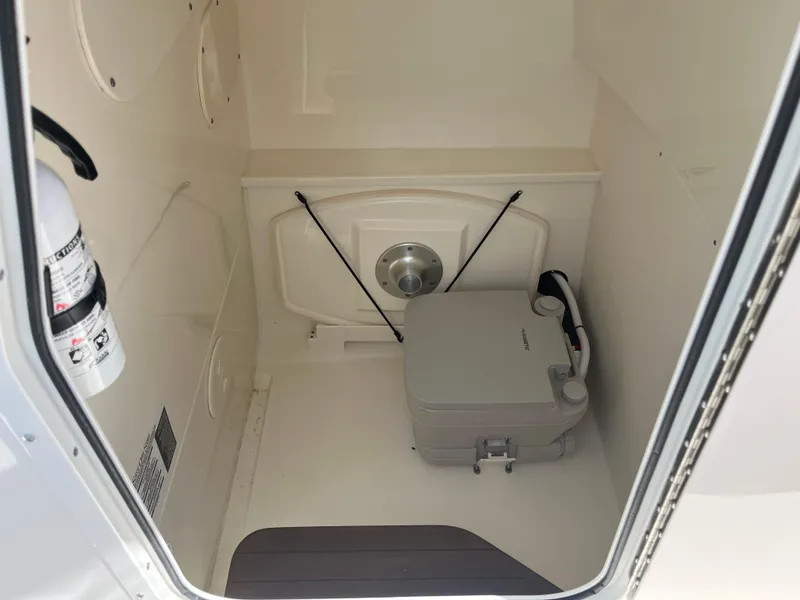 Slide: The Image of Interior of 2022 Boston Whaler 270 Dauntless boat with portable toilet and fire extinguisher. - 6