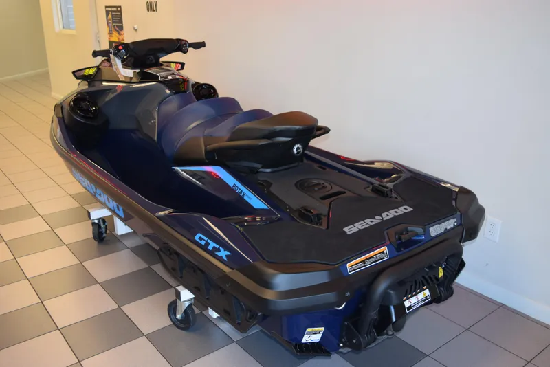 Slide: The Image of 2024 Sea-Doo GTX 230 jet ski displayed indoors on tiled floor. - 4