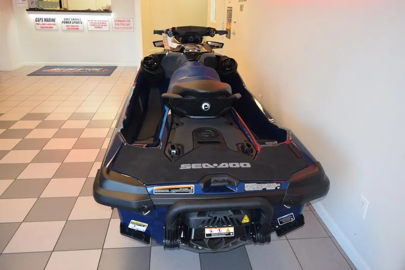 Slide: The Image of 2024 Sea-Doo GTX 230 jet ski in showroom, rear view, blue and black design. - 5