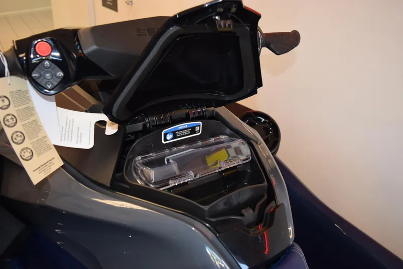 Slide: The Image of 2024 Sea-Doo GTX 230 storage compartment with open lid and control panel. - 8