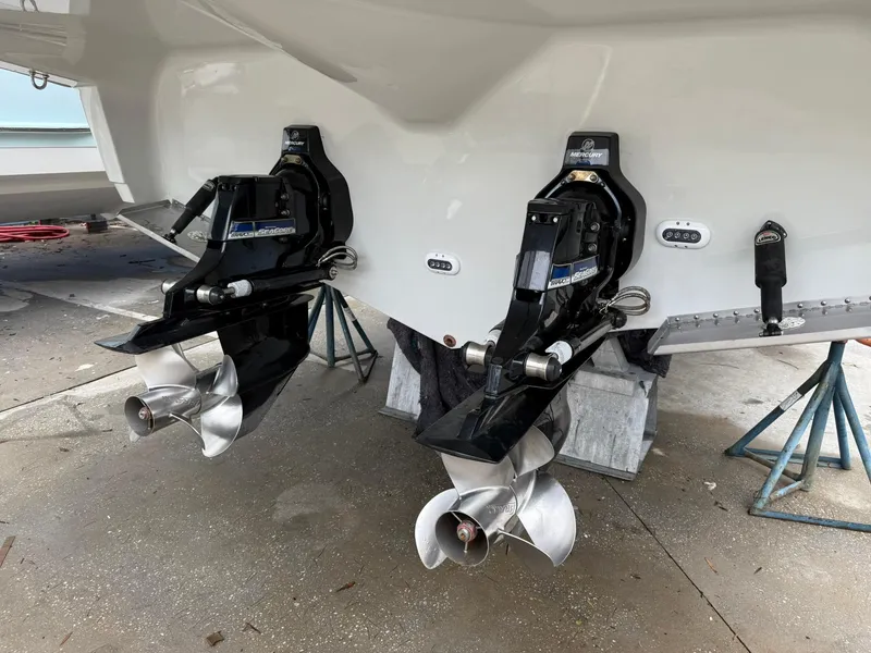 Slide: The Image of 2019 Crownline 350 SY boat with dual propellers on stands. - 10